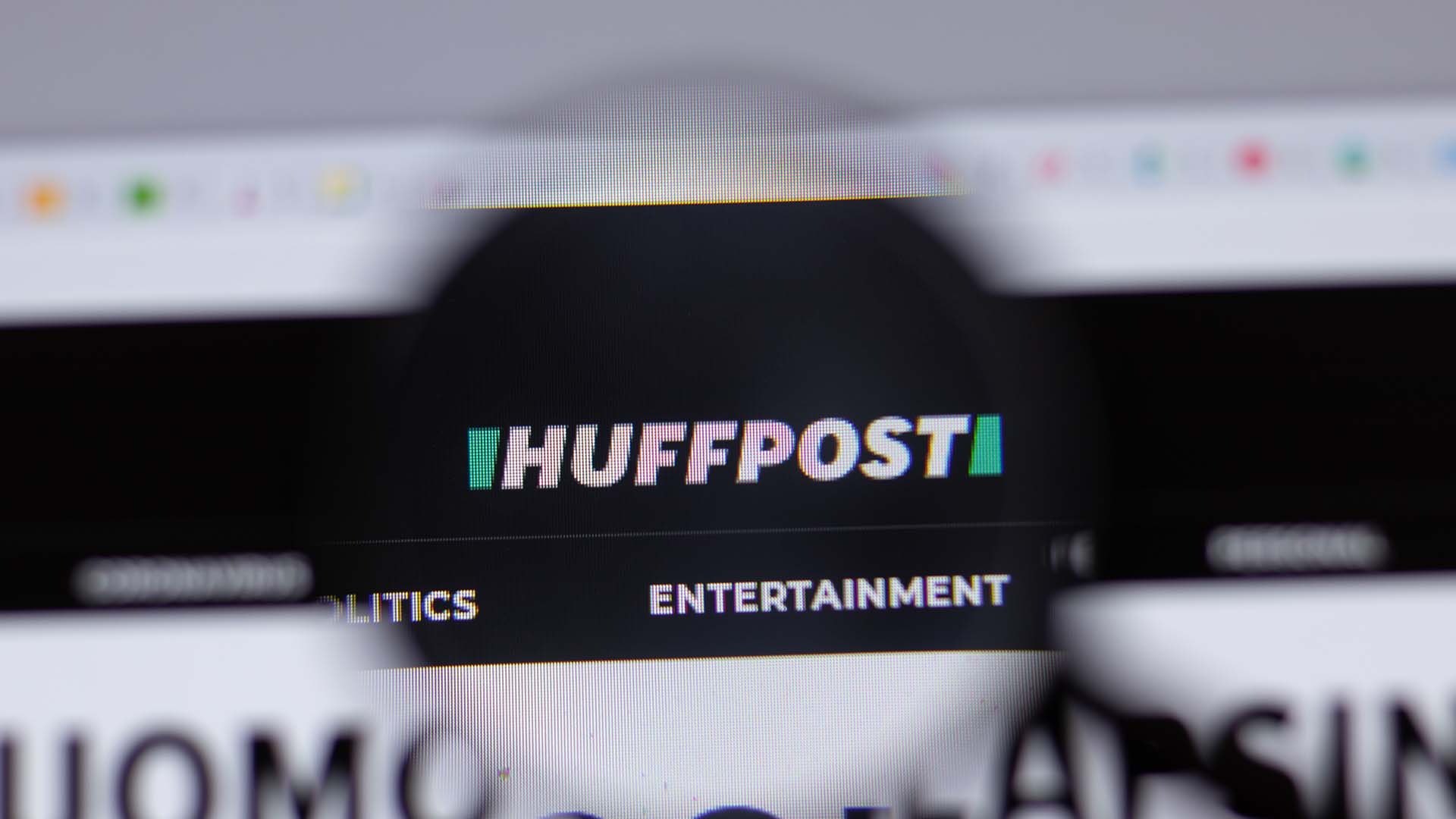 PC screen with blurred outline and the logo of Huffpost zoomed in and shown clearly.